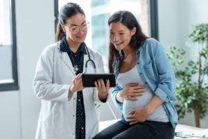 pregnant woman talking to doctor.